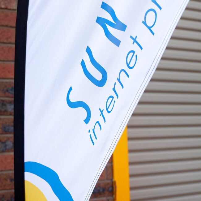 Close-up of a teardrop banner flag showing crisp dye-sublimation print on trilobal polyester fabric