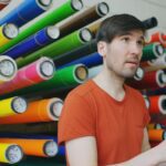 Colourful rolls of vinyl sticker material in a print workshop
