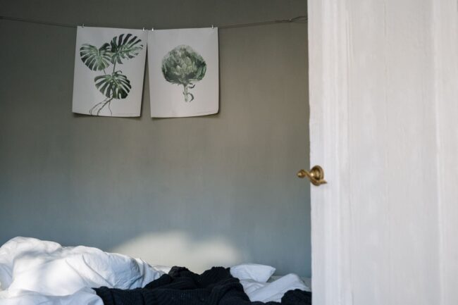 two large-format poster prints displayed on a wall