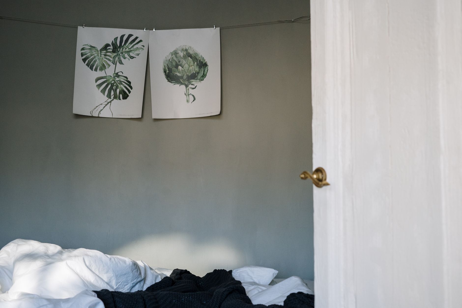 two large-format poster prints displayed on a wall