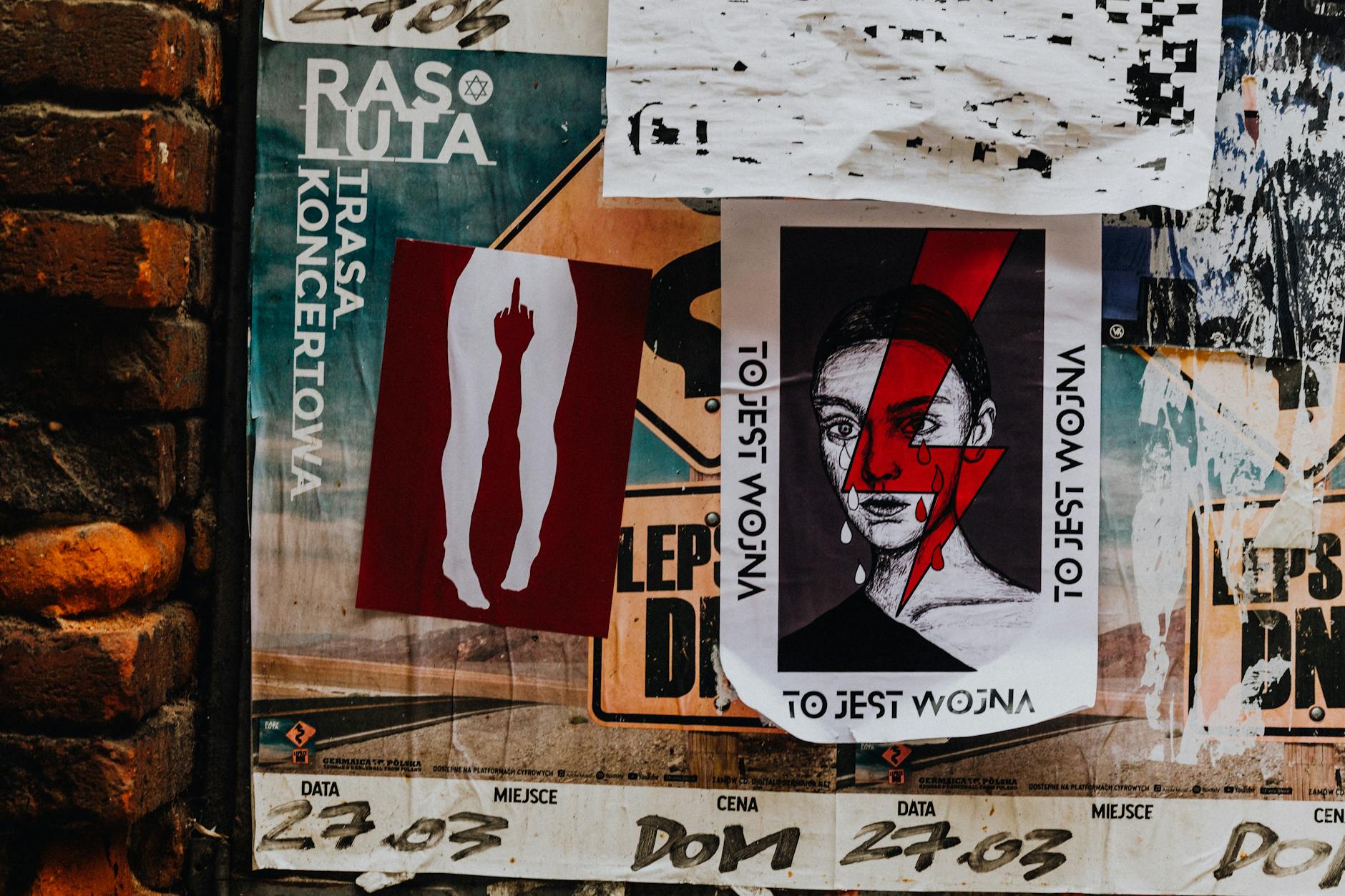 printed leaflets and posters attached to a city wall