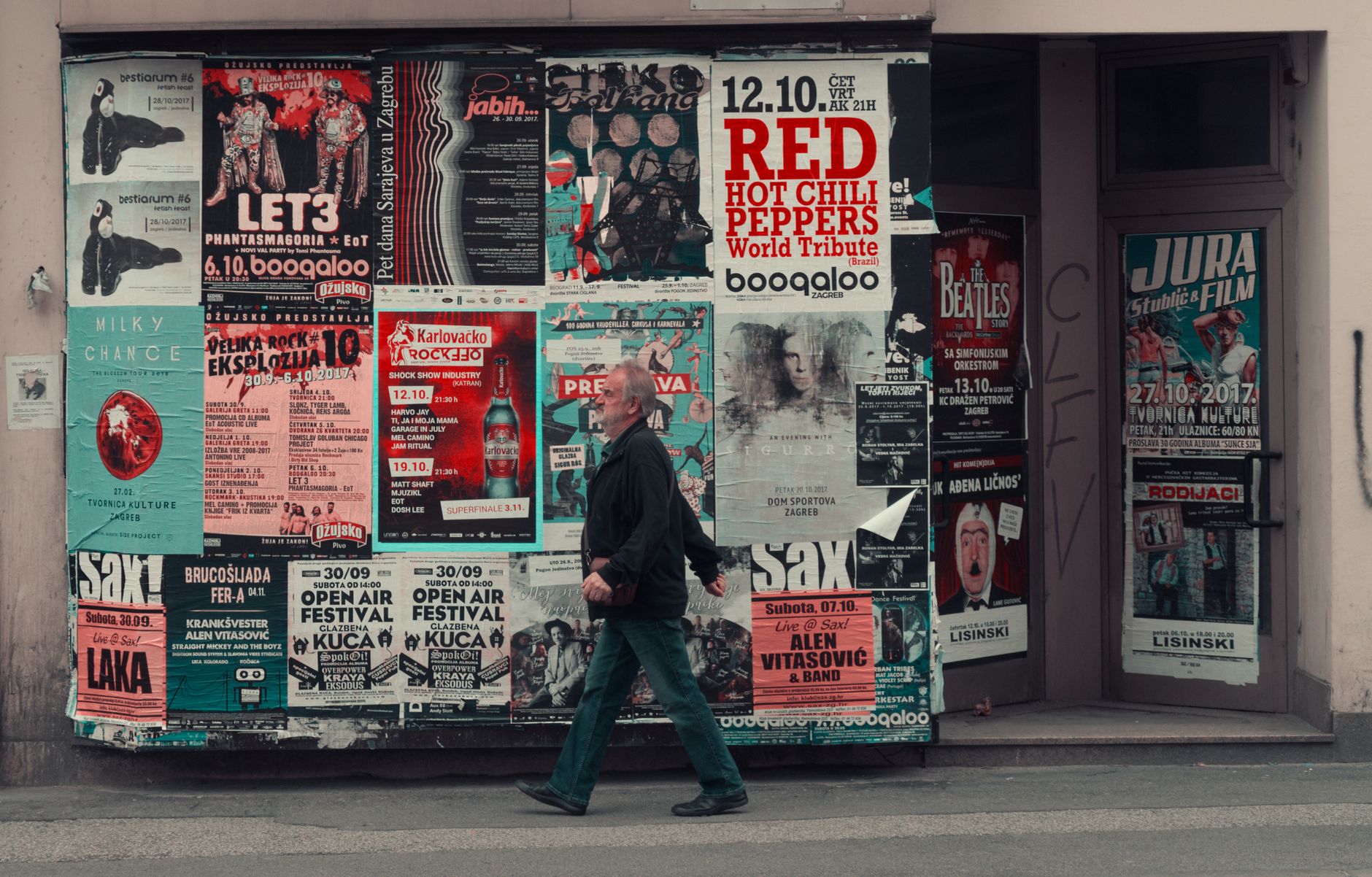 a tour poster promotion run showing A1 posters pinned to a music venue wall next to A2 posters in a bar window, with other gig flyers