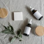 amber dropper bottles and a soap bar styled with botanical sprigs on linen
