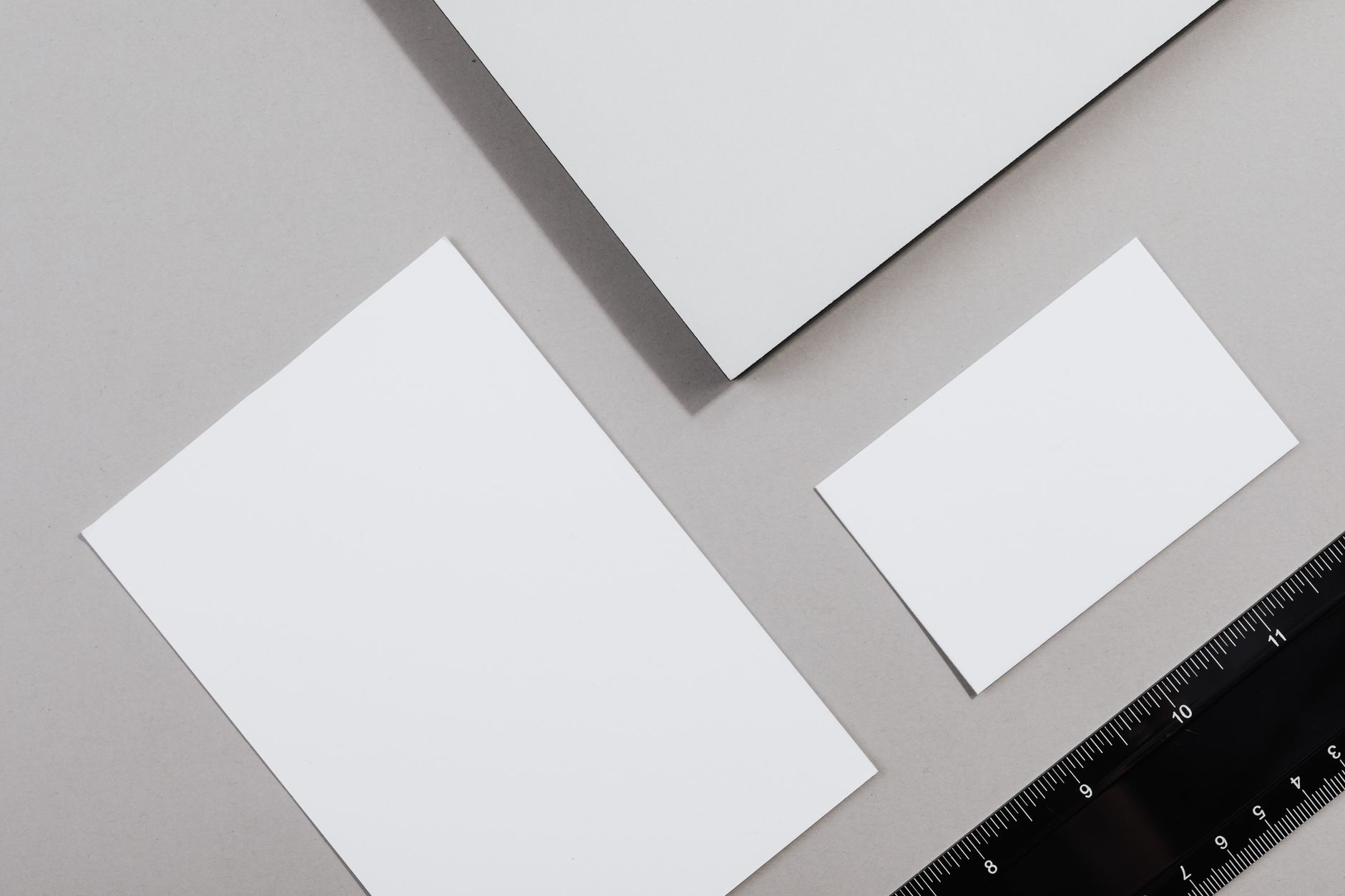blank paper sheets in different sizes laid out beside a ruler