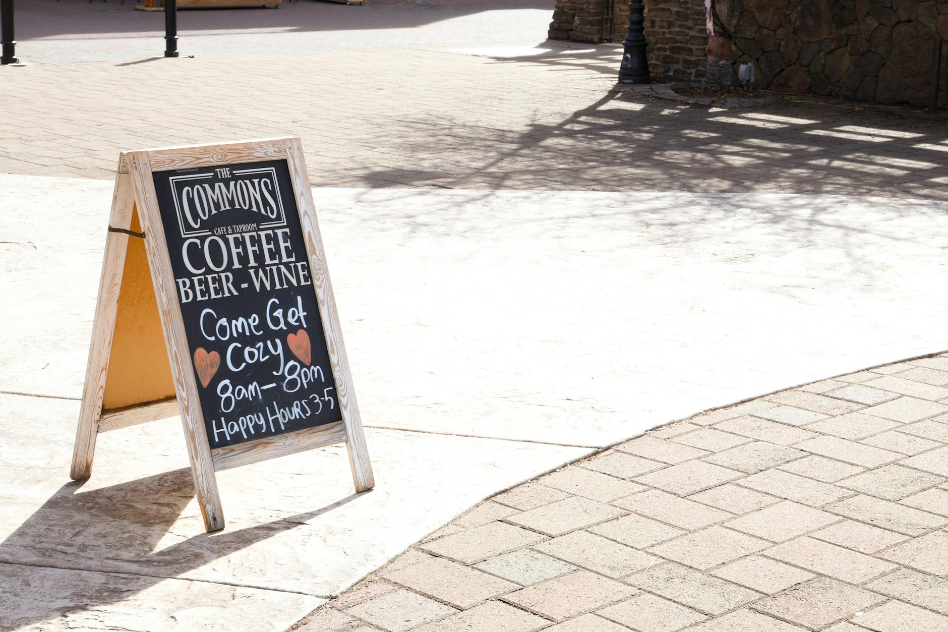 an A-frame chalkboard sign on the footpath outside a cafe