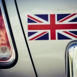 a printed Union Jack vinyl sticker applied to the rear panel of a car beside the tail light