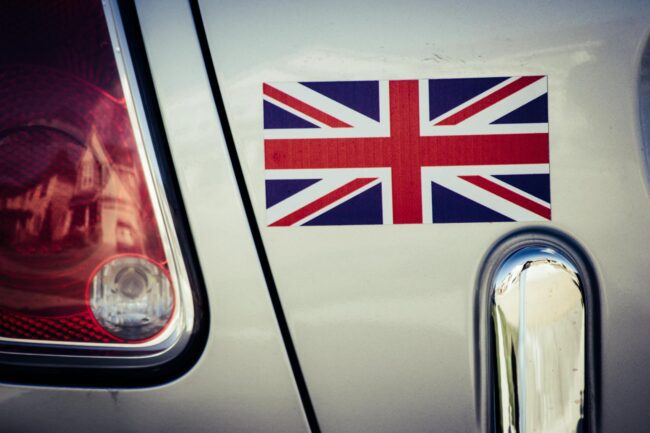 a printed Union Jack vinyl sticker applied to the rear panel of a car beside the tail light