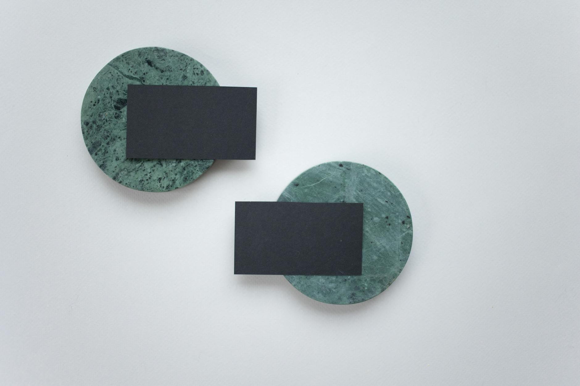 business cards displayed on dark stone coasters