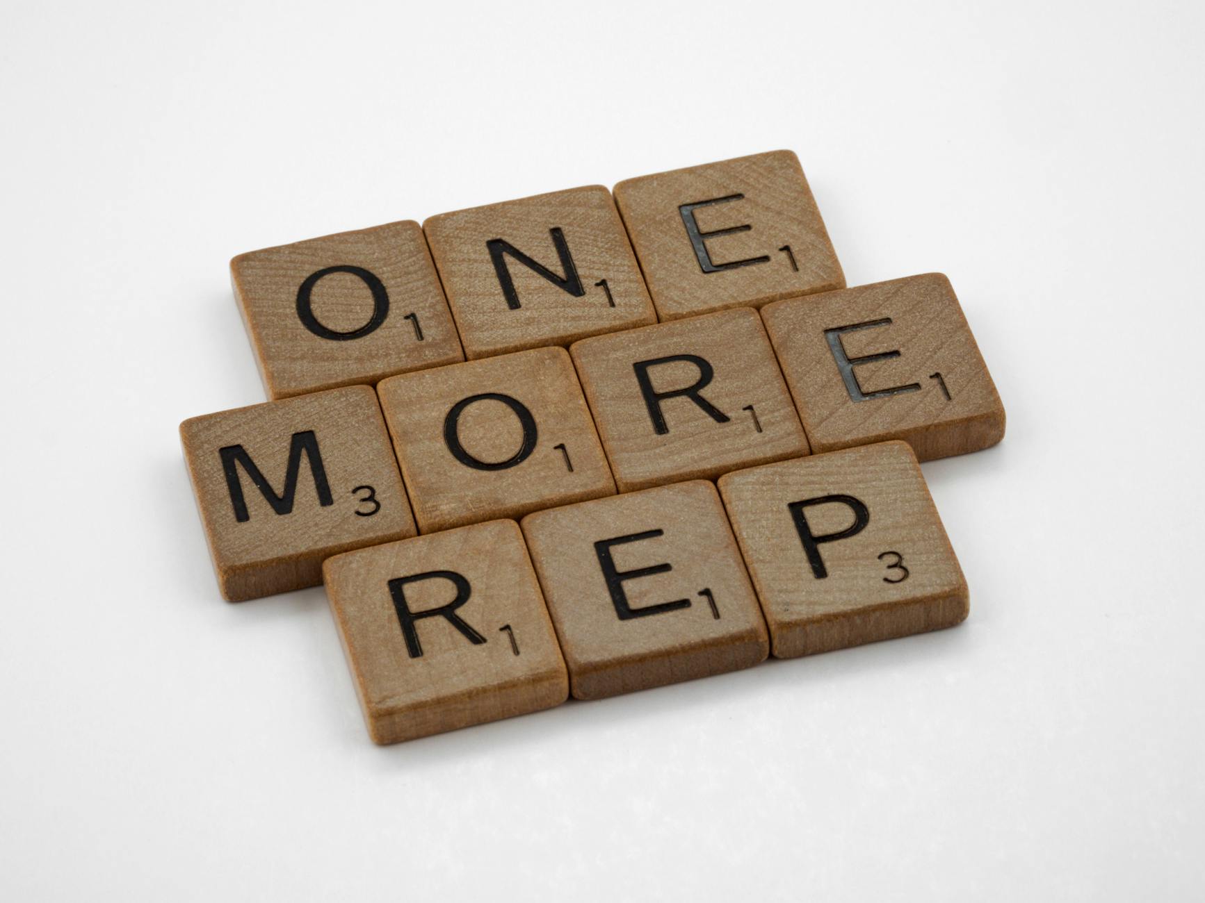 letter tiles spelling one more rep, gym motivation