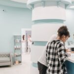 patients holding printed forms at a medical centre reception desk