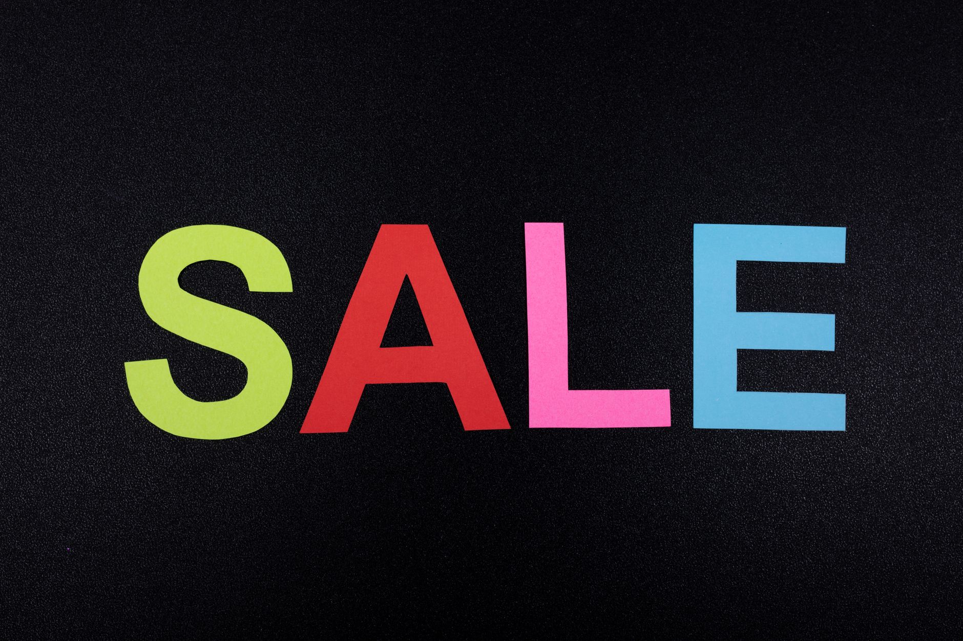 A bold A1 EOFY sale poster showing a large percentage discount on a bright yellow background, mounted on a poster stand inside a retail