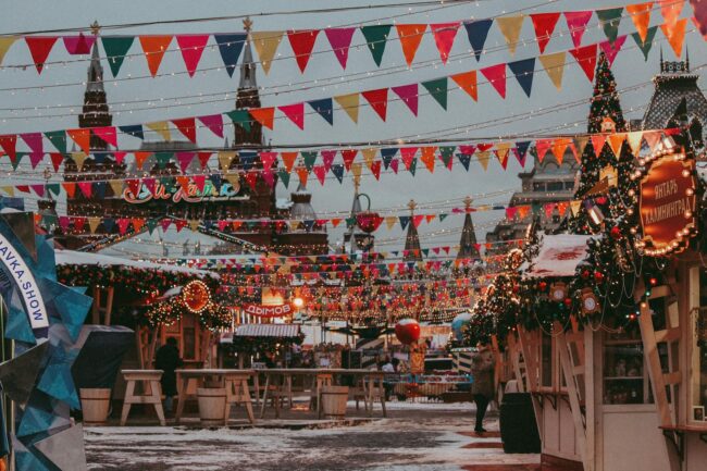 colourful bunting strung above market stalls at a busy outdoor festival