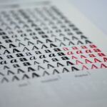 a spread of printed samples arranged by weight from thin leaflets to thick business card stock, on a clean white table