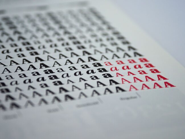 a spread of printed samples arranged by weight from thin leaflets to thick business card stock, on a clean white table