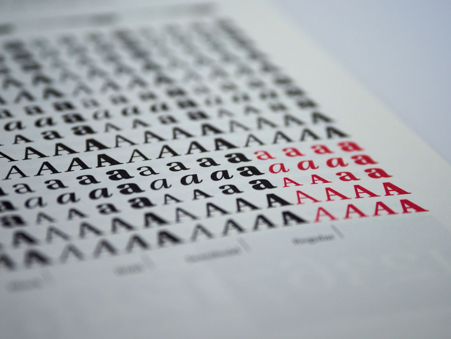 a spread of printed samples arranged by weight from thin leaflets to thick business card stock, on a clean white table