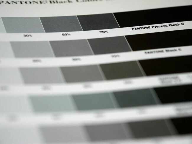Side-by-side print swatch showing an RGB neon blue next to its CMYK-converted equivalent, both labelled, illustrating visible colour shift