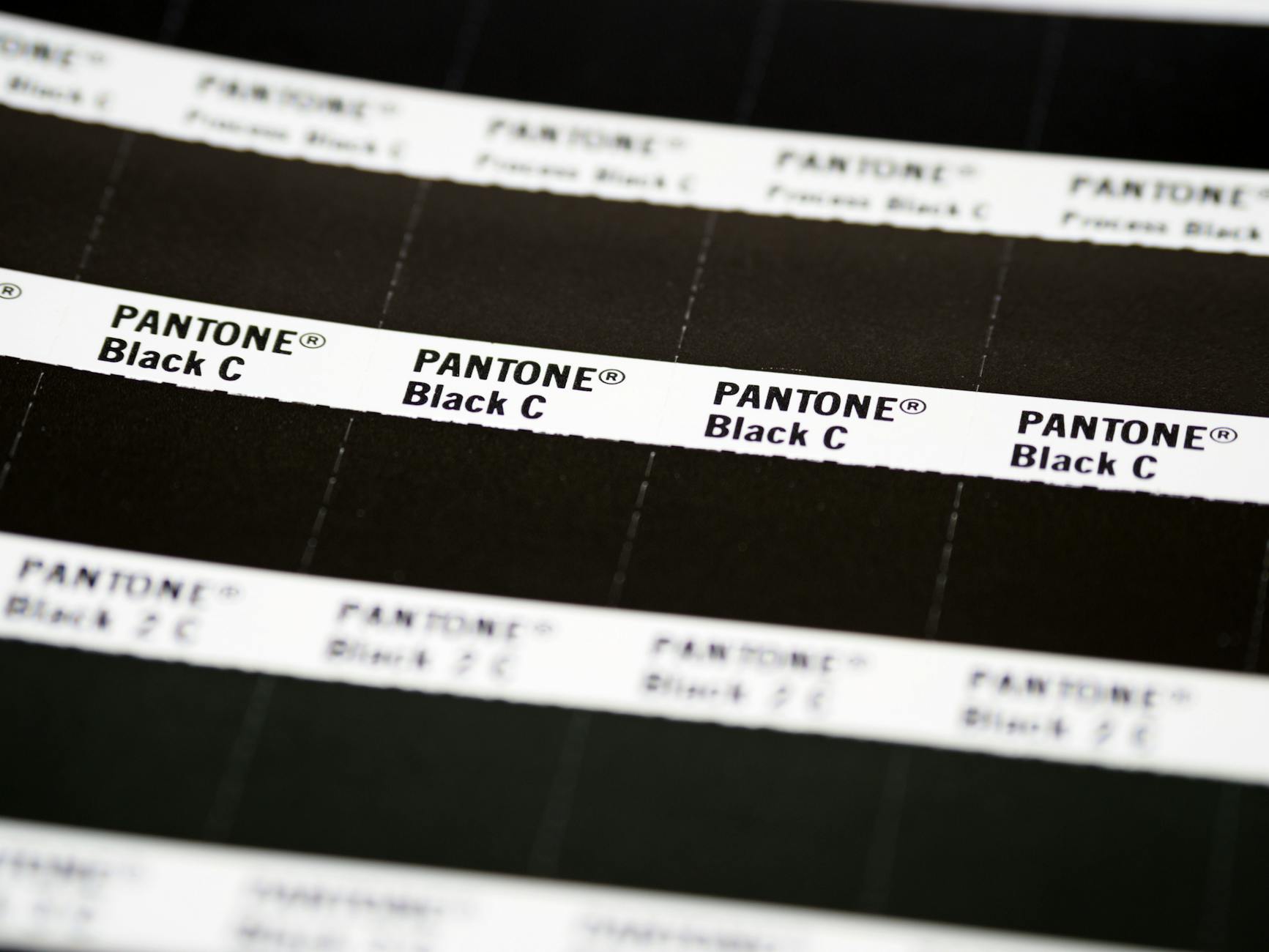 a printer's Pantone colour swatch book showing solid colour reference chips