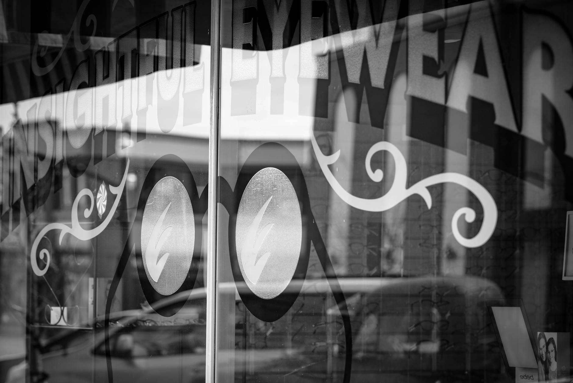 white vinyl lettering applied across a storefront glass window
