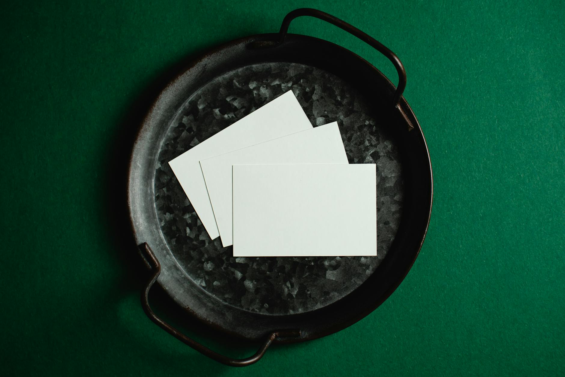 overhead shot of business card print-ready artwork file on a computer screen showing bleed and safe zone guides