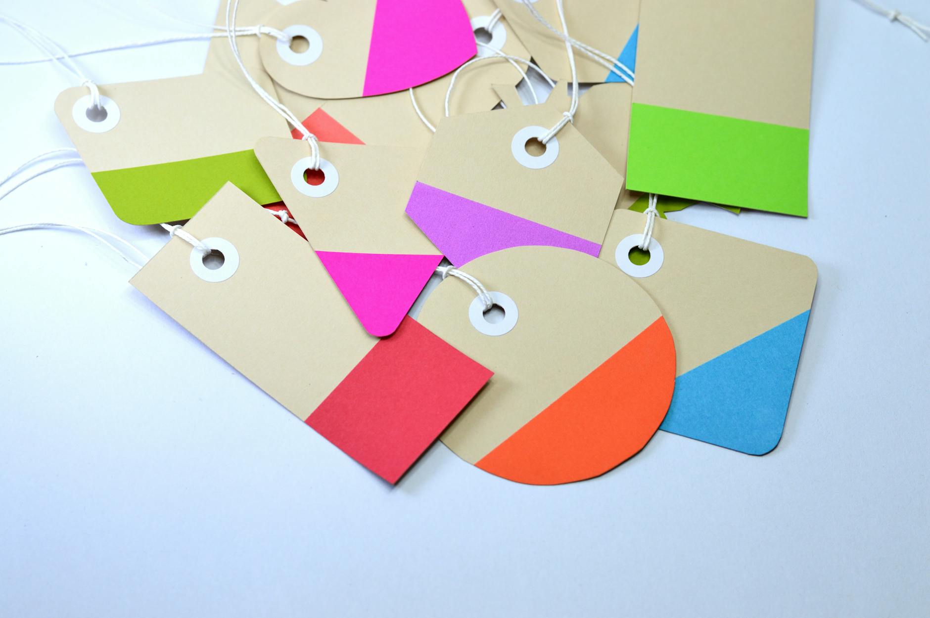 a set of custom rectangle labels printed with a clean design, shown being peeled off a glass bottle cleanly without leaving residue