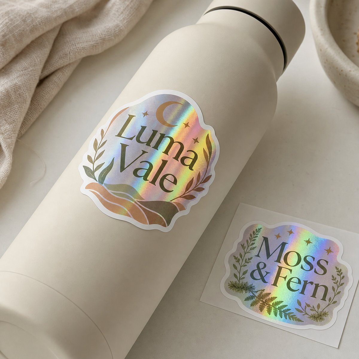 A die-cut holographic sticker with an iridescent rainbow finish that shifts colour in the light