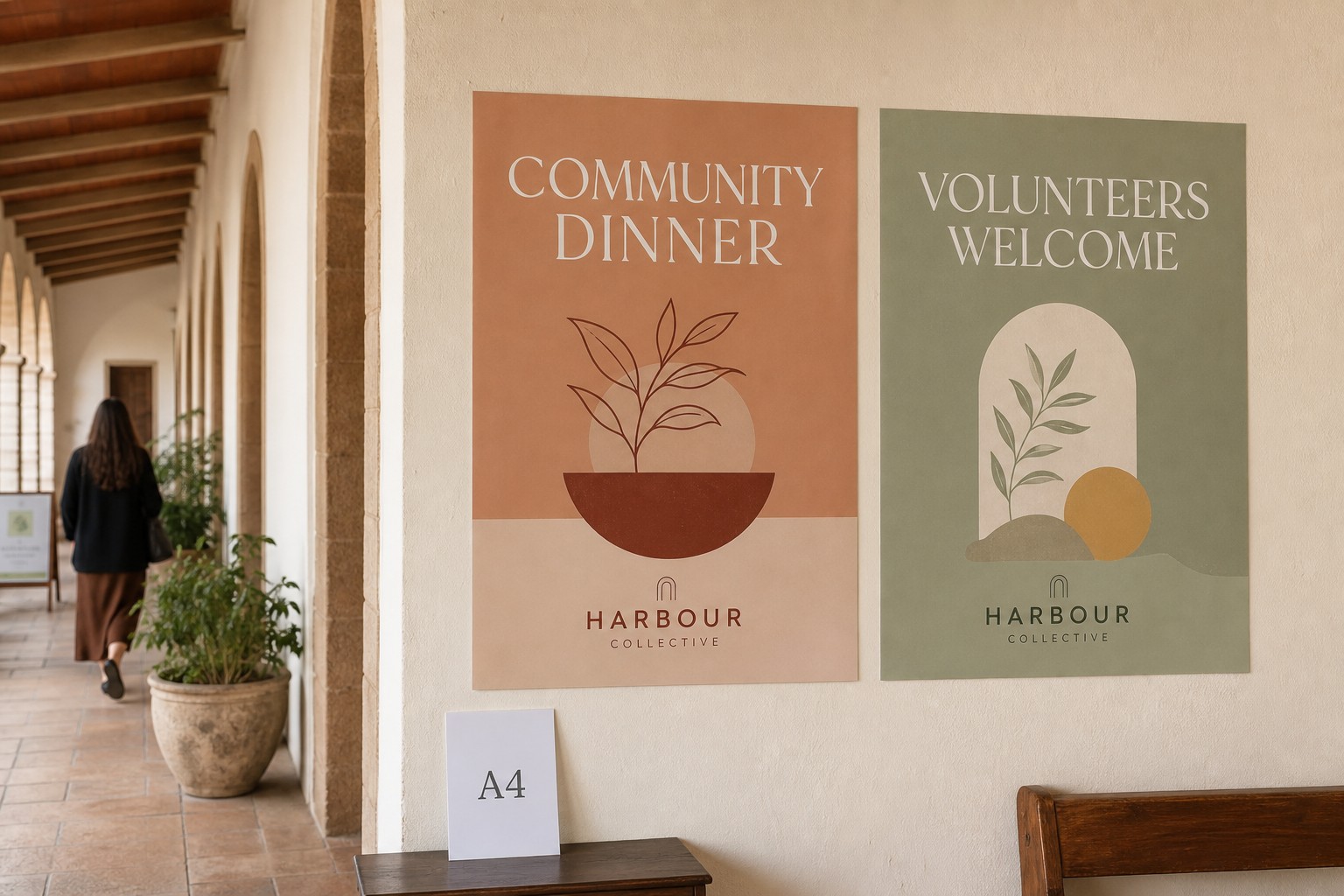 Two A2 synthetic posters mounted on a church corridor wall showing a community dinner announcement and a volunteer recruitment notice