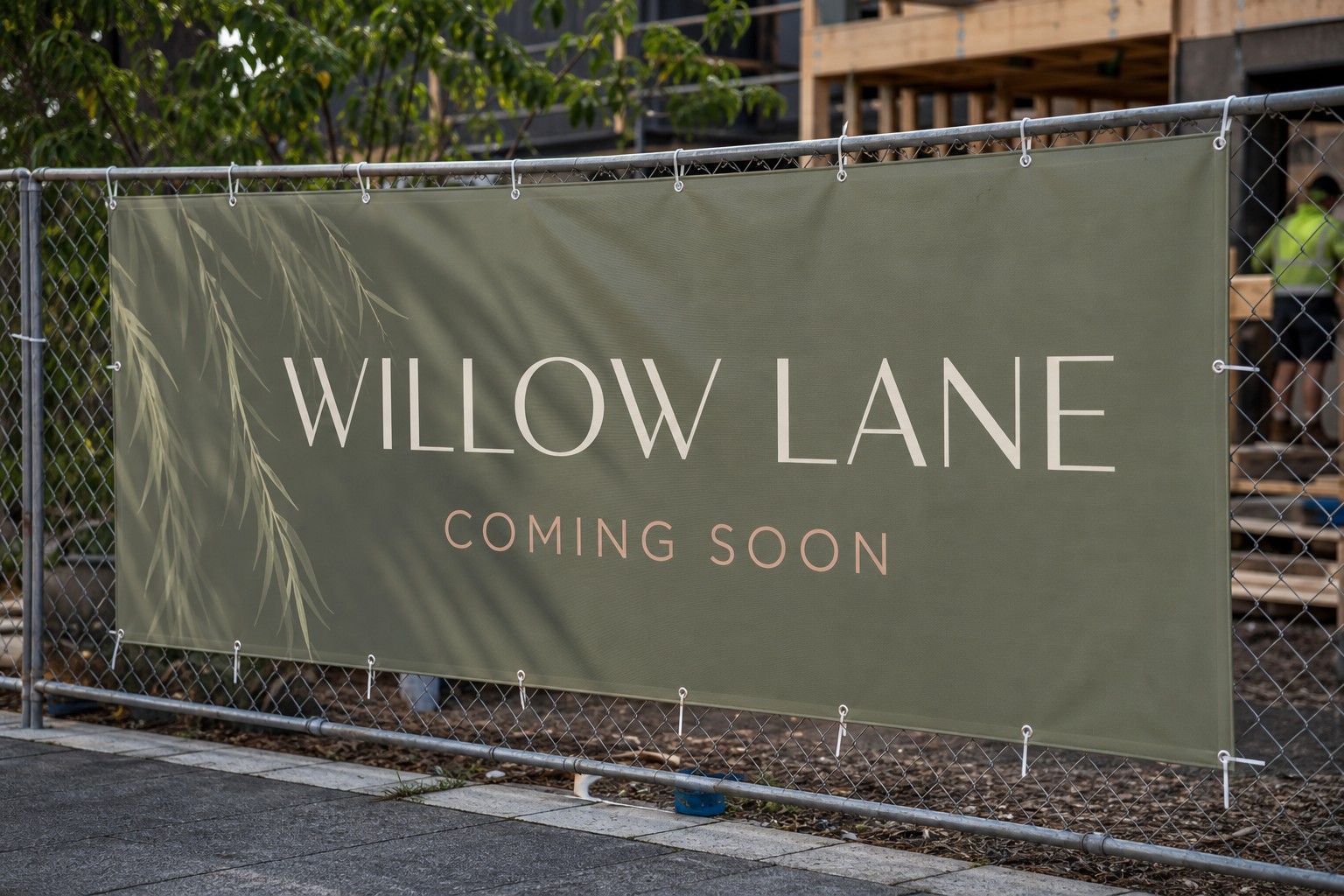 Coming-soon hoarding panel · solid PVC vinyl · full-colour digital print · matte finish · cable-tied to temporary fencing