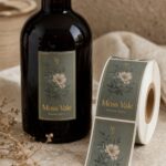 Foil label on a spirits bottle · foil-on-CMYK process · full-colour print with gold metallic foil accents · matte label stock