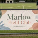 Outdoor PVC vinyl banner · 440-510gsm PVC · full-colour solvent print · hemmed edges and corner eyelets · cable-tied to a sports-ground fence