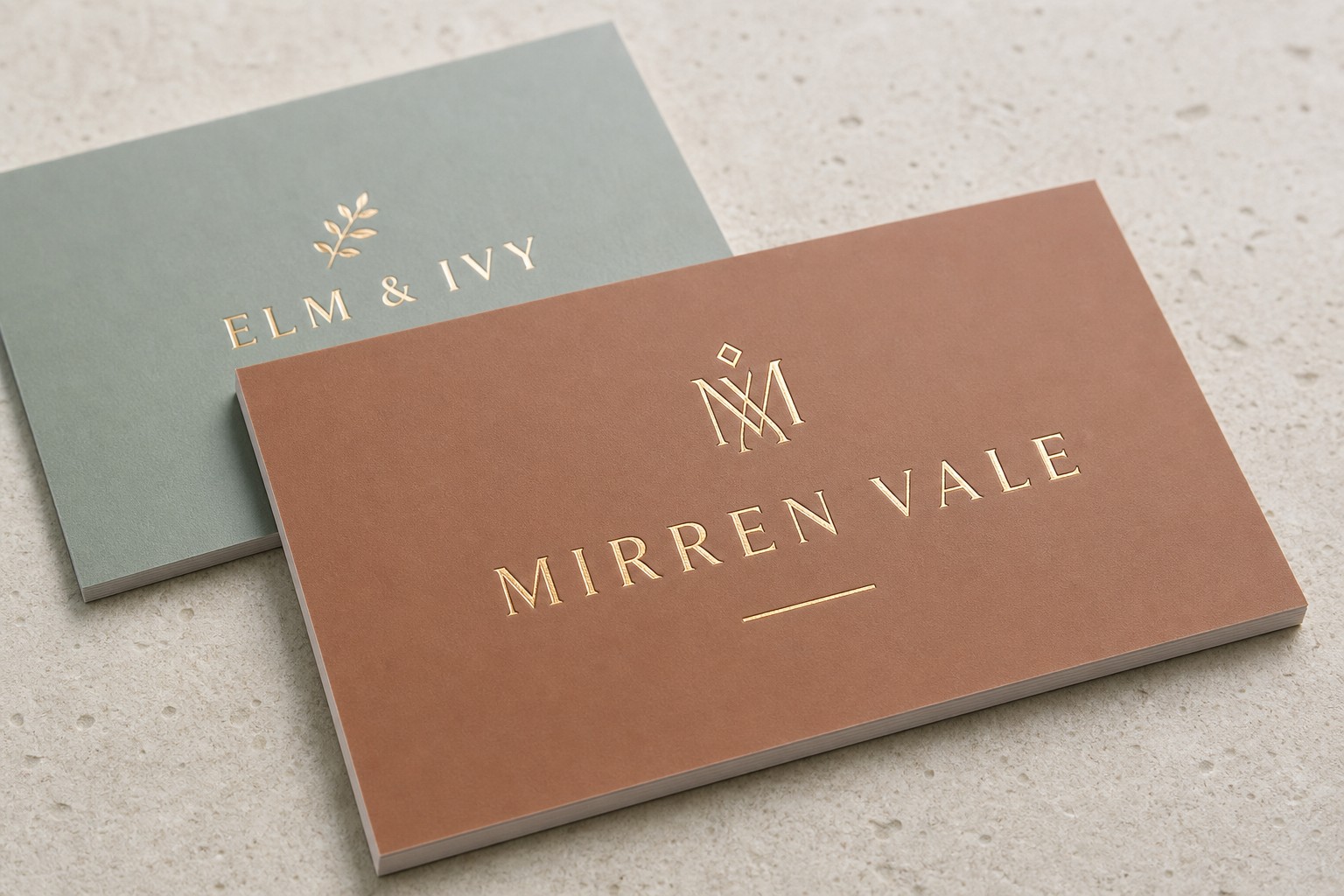 Raised-foil business card · velvet matte laminate · gold foil applied with heat and pressure · dimensional foil proud of the velvet-matte surface