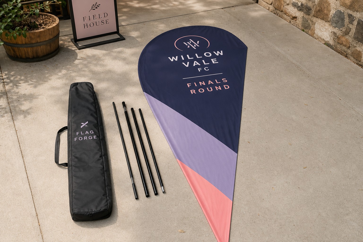 A replacement teardrop banner skin laid flat beside a set of fibreglass poles and carry bag