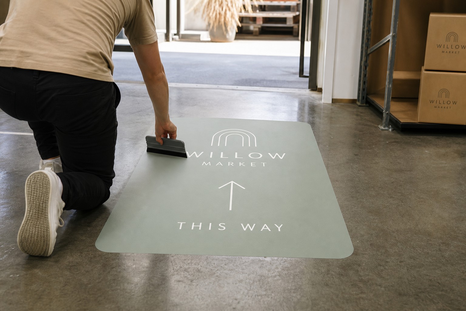 Step-by-step application of a custom floor decal on sealed warehouse concrete