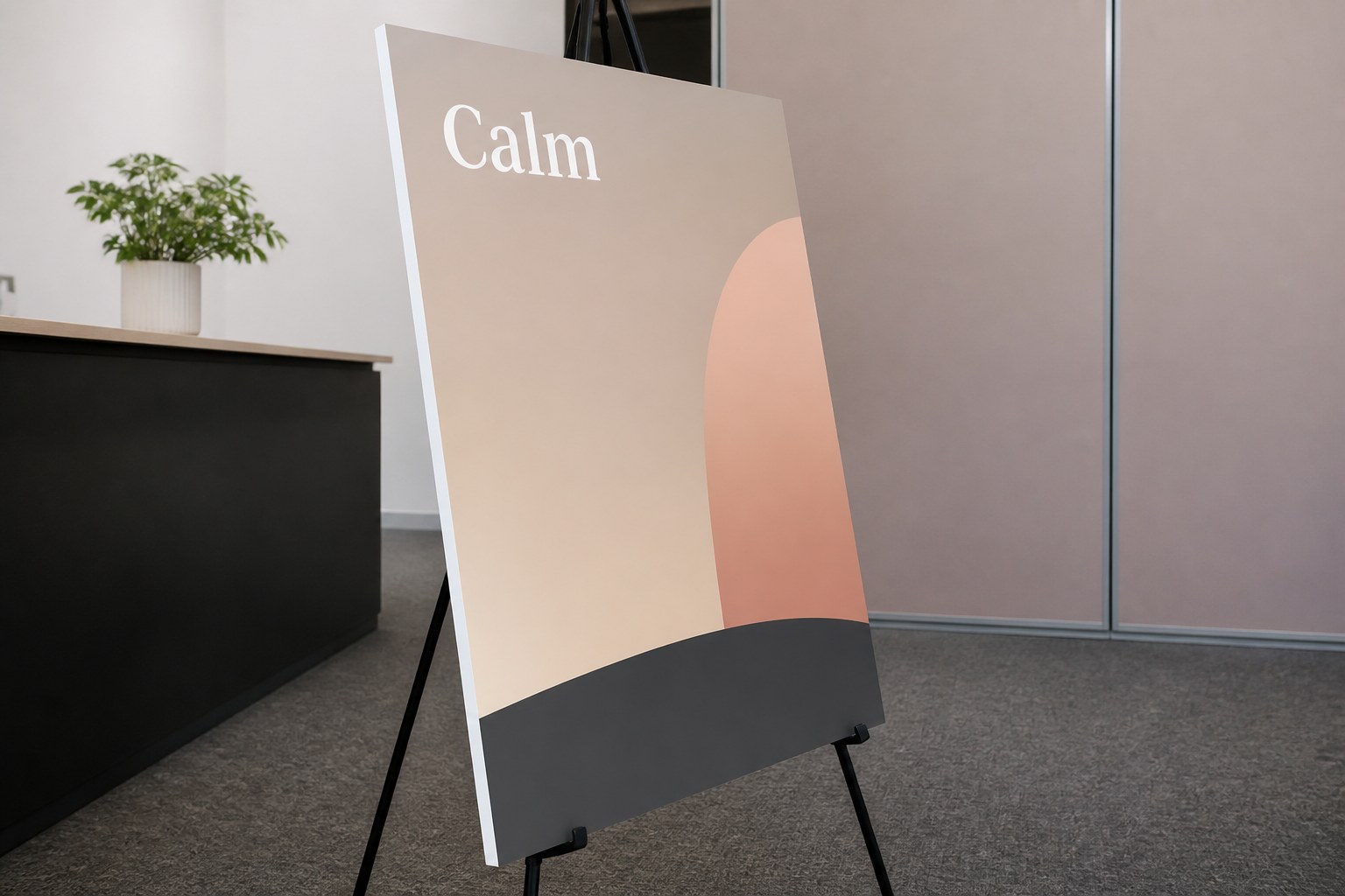 Large printed foam board panel upright on a slim black floor easel, its white cut edge visible against grey carpet at an exhibition stand