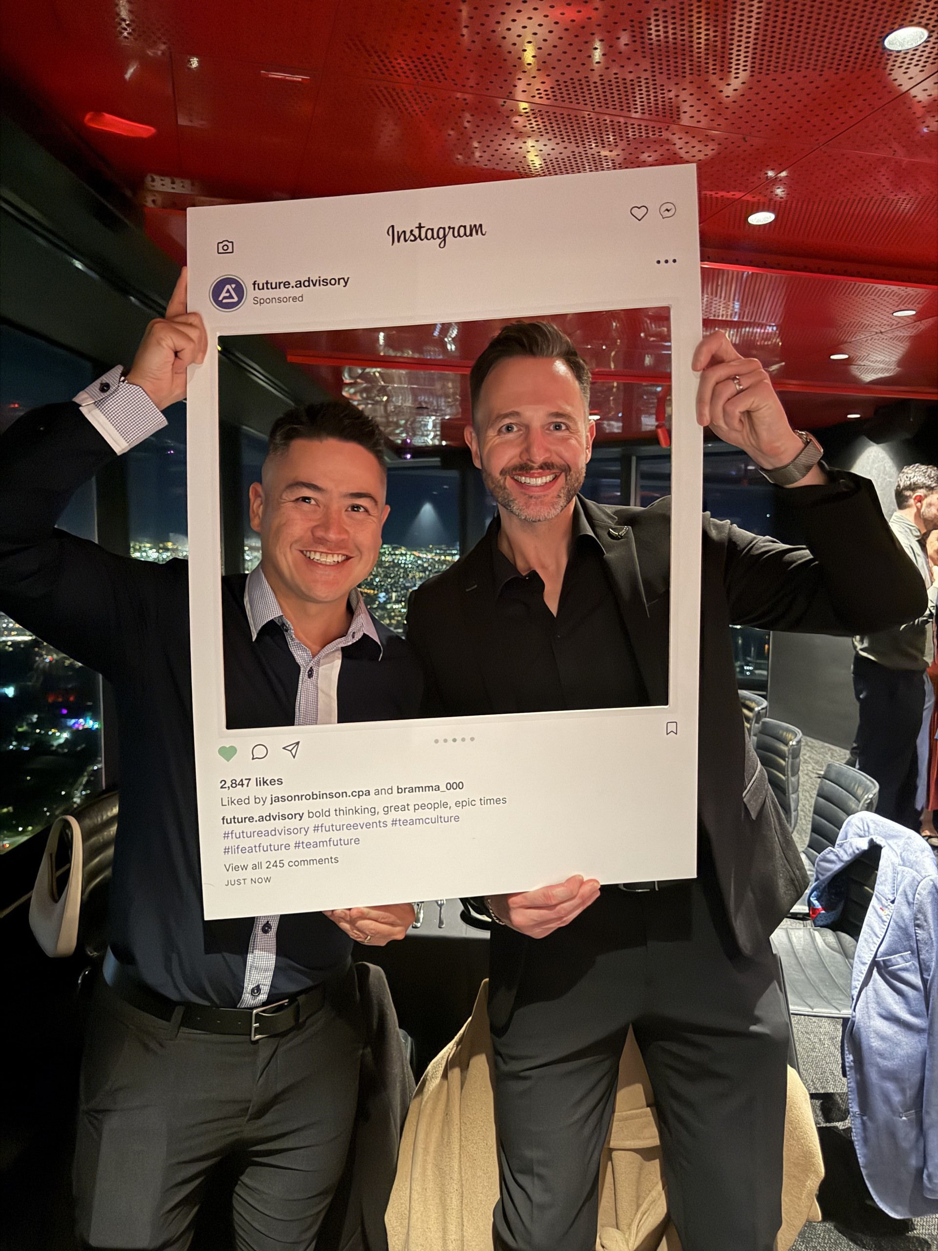 Custom Instagram selfie frame printed for the Future Advisory end of financial year celebration, held up by two of the team