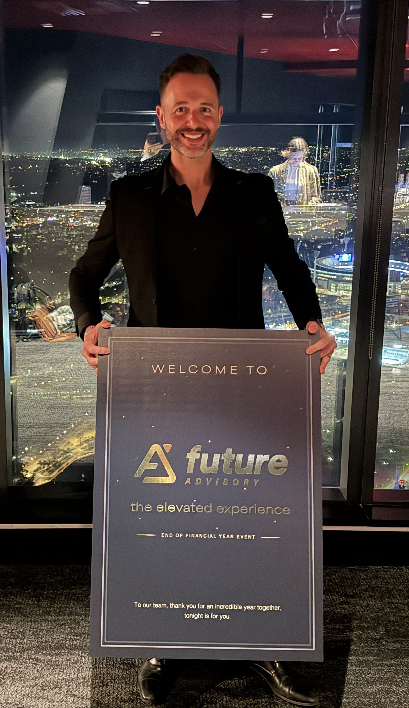 Custom printed Future Advisory welcome sign for the end of financial year event, standing beside the city view windows at Eureka Tower