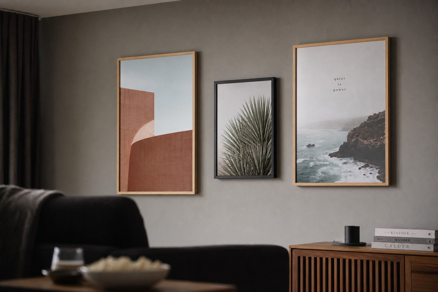 Framed prints · solid wood frames · shatterproof plexiglass · three prints on a plain grey wall