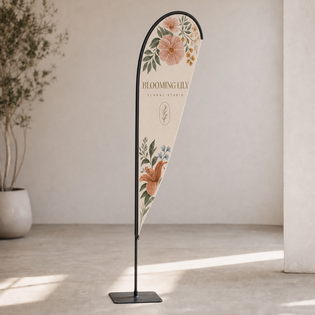 Teardrop flag held upright by a flat square metal plate base on a hard indoor floor