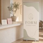 Premium pull up banner in a studio · 850 x 2100 mm · full-colour digital print · silver base