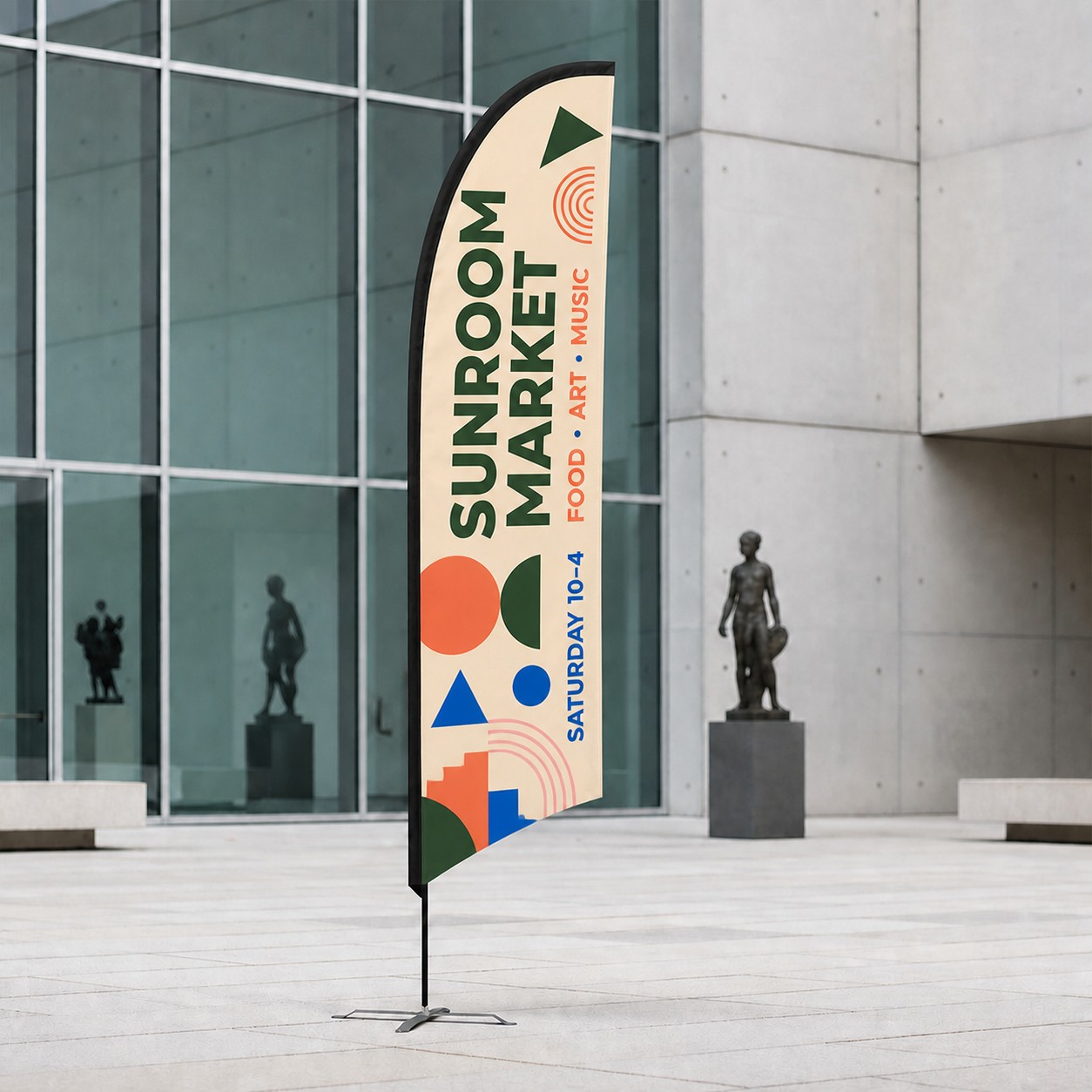 Replacement flag teardrop skin on flexible pole in cream, forest green, blue and coral print in concrete courtyard with glass grid facade