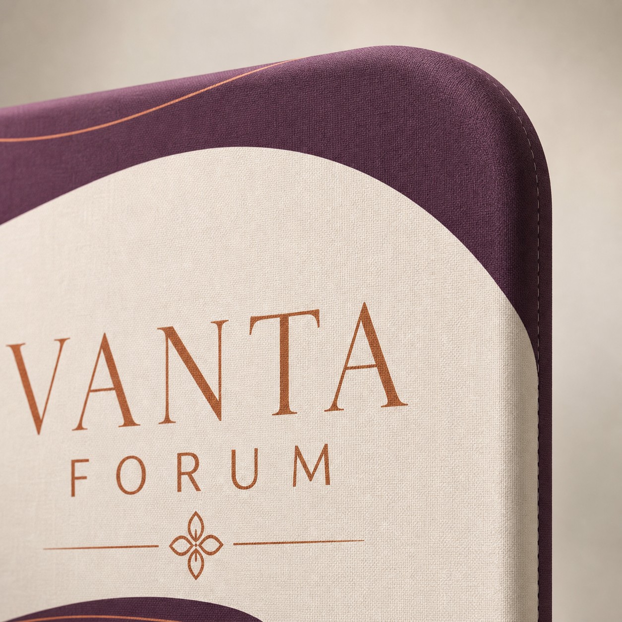 Stretch fabric media wall, close up with plum, white and orange print, fabric wrapping curved frame edge, weave visible, plain background.