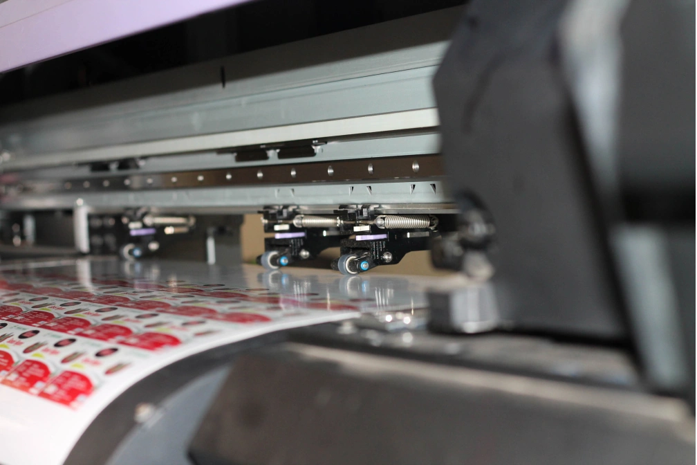 Rows of small red and white sticker designs · printing · before cutting