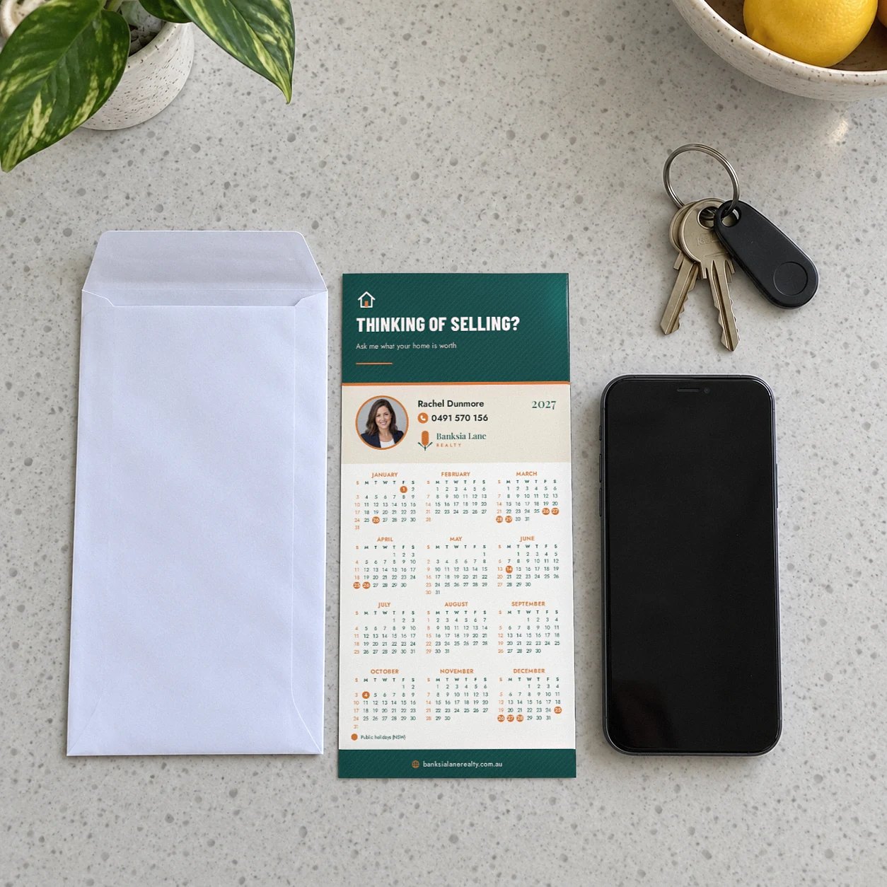Appraisal offer layout DL magnetic calendar reading THINKING OF SELLING? on a stone bench beside a DL envelope and a phone