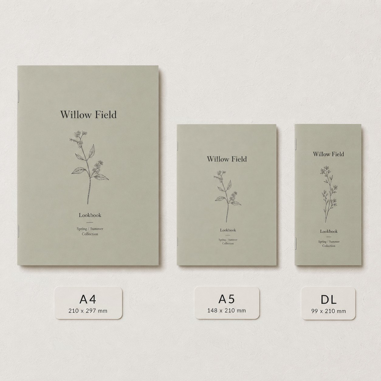 Three sage green booklets in three sizes on pale background with botanical line drawing covers and size labels