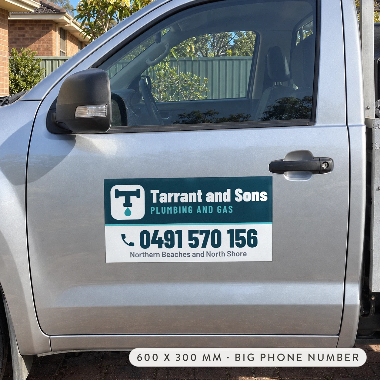 Magnetic car door sign on a silver ute driver door with a dark teal upper panel and a white panel below for a large phone number and service area.