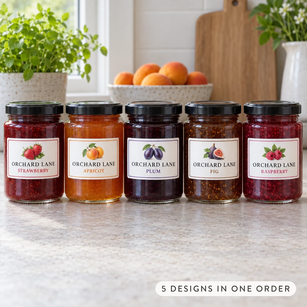 Five small jam jars with black lids in a row on a pale stone bench, each with a white rectangle label and a different fruit illustration