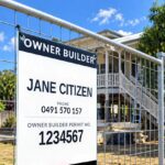 Queensland owner builder sign with navy OWNER BUILDER header, name, phone number and permit number cable tied to mesh fencing