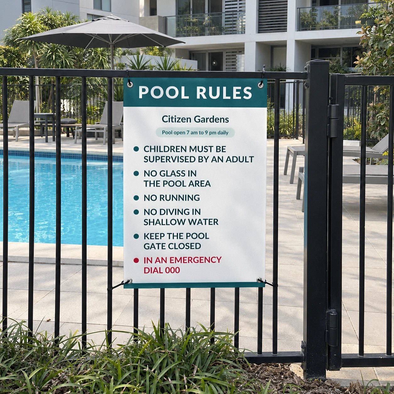 600 x 900mm pool rules sign with teal header and six rules cable tied to a black pool fence beside the gate