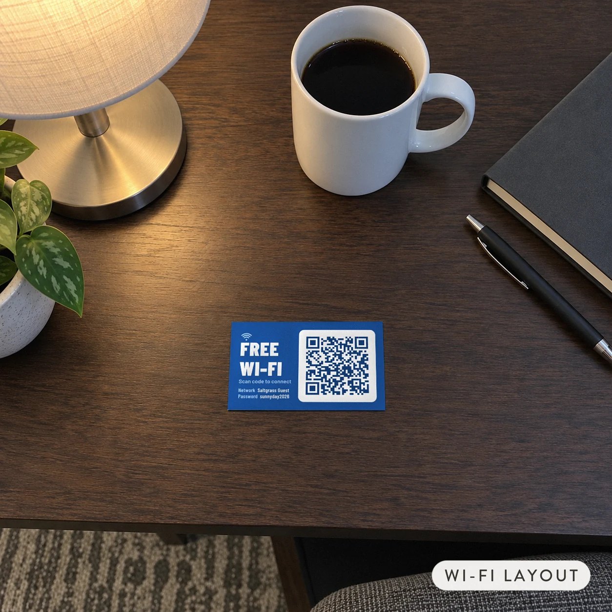 90 x 55mm blue Wi-Fi QR code card with FREE WI-FI, signal mark, QR code and printed network details on a timber hotel desk
